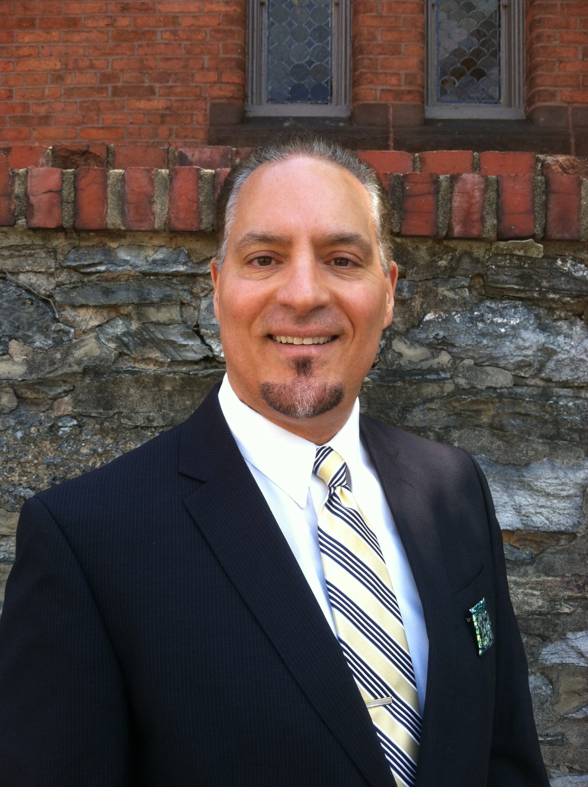 A smiling man in formal suit